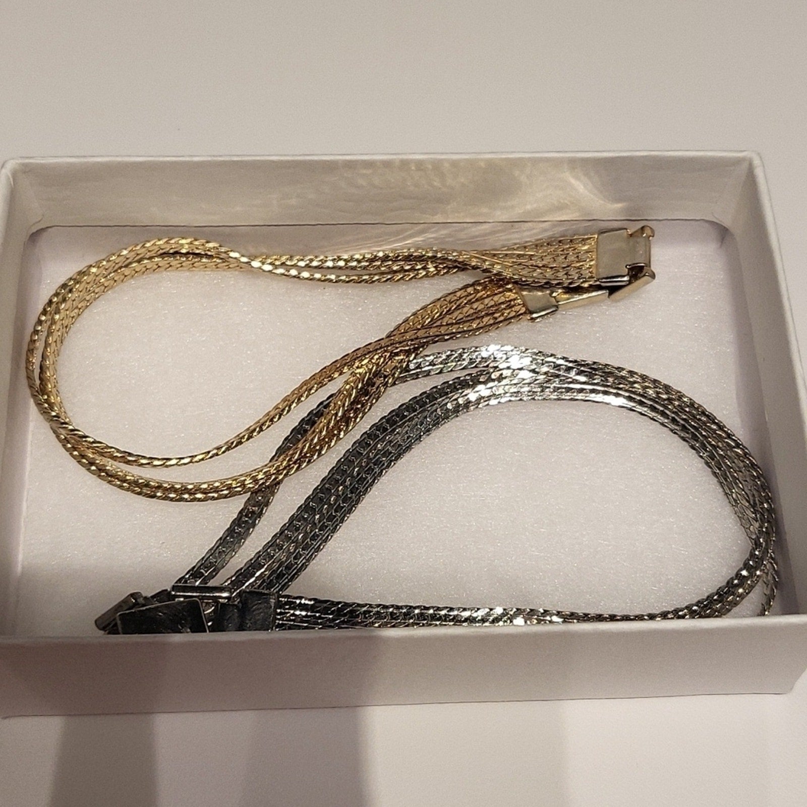 Set of 2 triple strand fashion bracelets in silver and gold