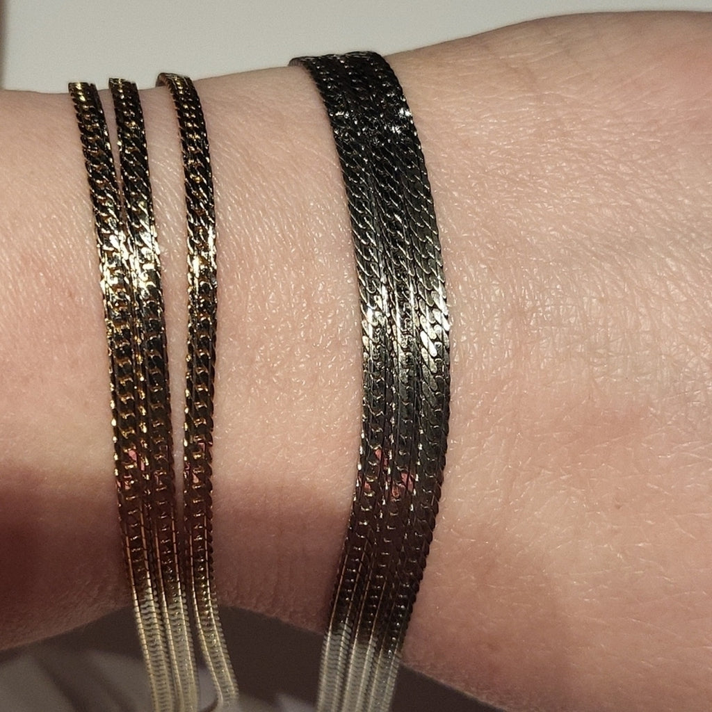 Set of 2 triple strand fashion bracelets in silver and gold